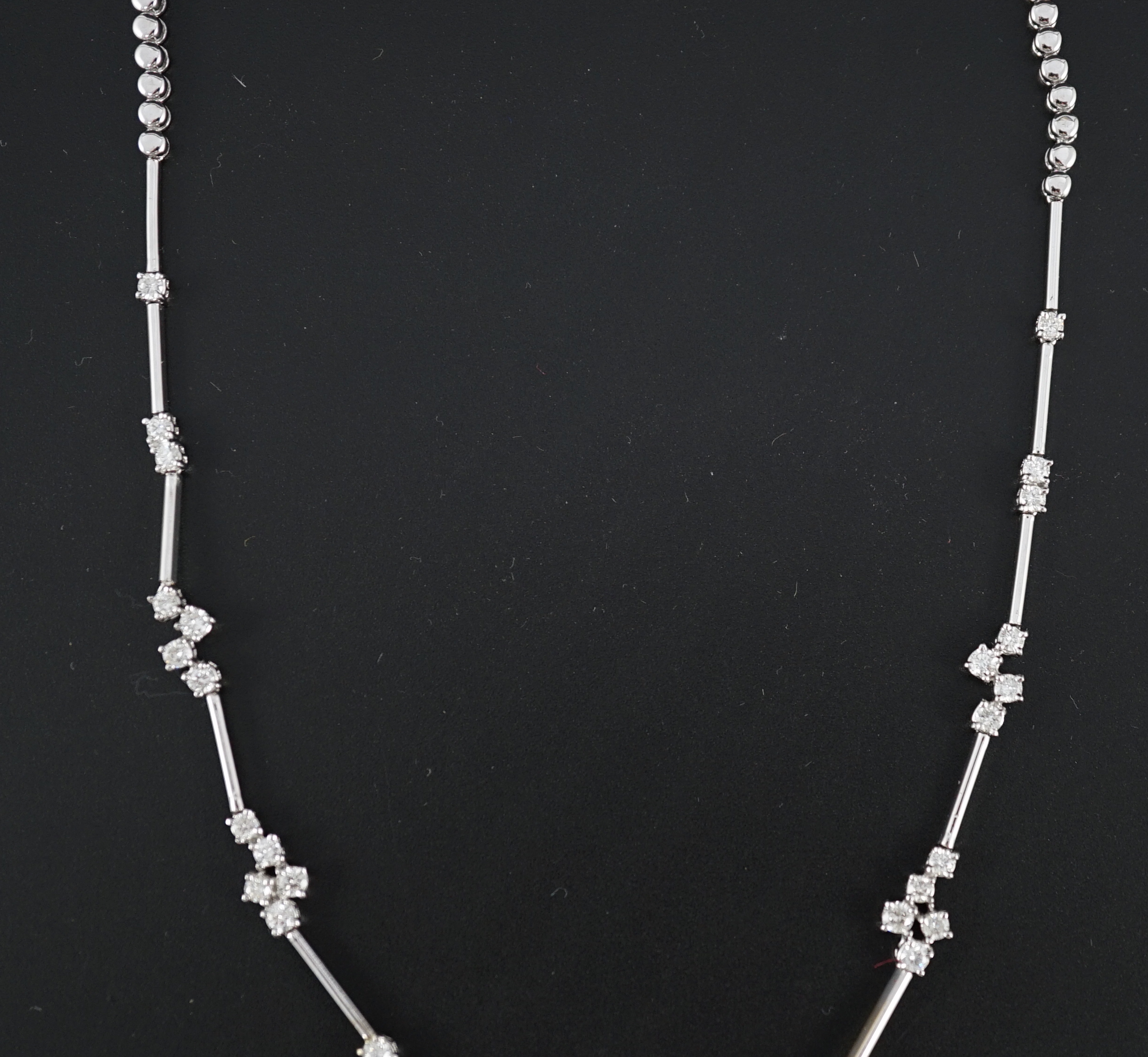 A modern 18k white gold and diamond cluster set necklace